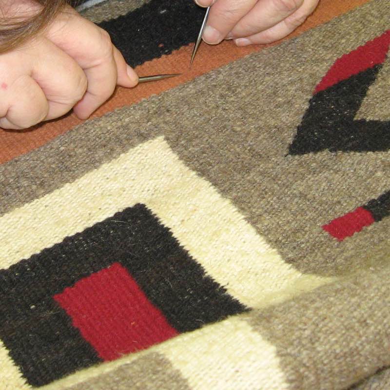 Photo-documenting and inspecting a hand-knotted area rug before cleaning