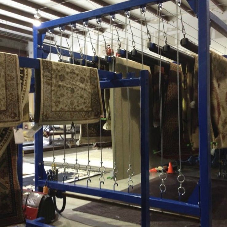 Hand-knotted rugs drying in a climate-controlled facility